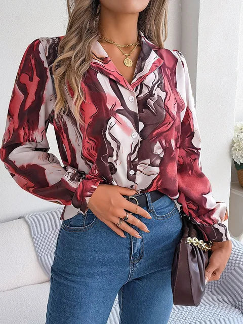 Elegant tie-dye women's shirt with autumn puff long sleeves, red and white pattern, casual blouse style, paired with jeans and accessories.