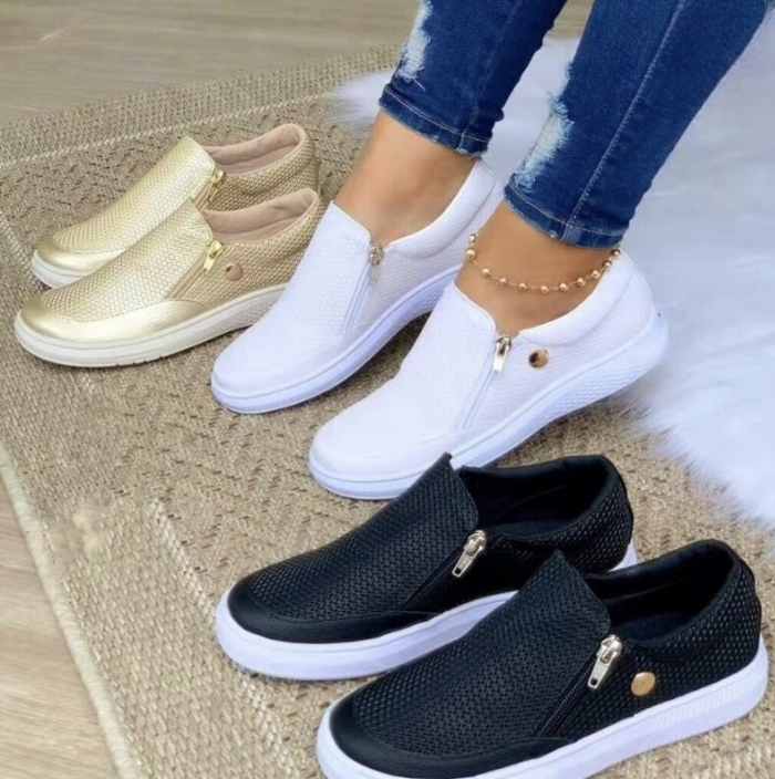 Women's casual slip-on sneakers in gold, white, and black on a woven rug. Breathable, flat vulcanized shoes ideal for spring and summer fashion.