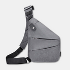 Sleek grey crossbody sling bag with adjustable strap, multiple zippered compartments, and modern design. Ideal for travel and daily use.