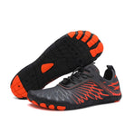 Gray and orange minimalist barefoot running shoes with flexible soles, designed for comfort and performance. Ideal for trail running and fitness.