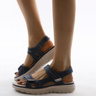 Women's navy blue orthopedic sandals with adjustable straps and cushioned soles, designed for comfort and support, ideal for walking and casual wear.