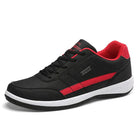 Black and red athletic sneaker with white sole, featuring a sleek design and comfortable fit. Ideal for running, walking, and casual wear.