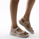 Beige women's platform sandals with adjustable straps, cushioned sole, and open-toe design, perfect for summer fashion and casual wear.