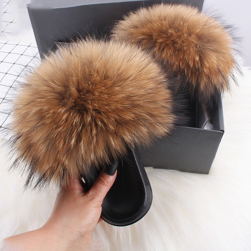 Fluffy brown faux fur slippers in a black box, perfect for cozy indoor wear. Luxurious, soft, and stylish footwear for comfort and warmth.