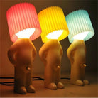 Colorful human-shaped table lamps with pleated shades in red, yellow, and blue. Unique modern home decor lighting for living room or bedroom.