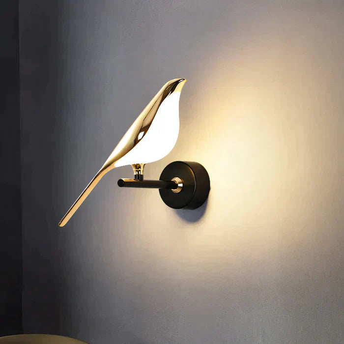 Modern bird-shaped wall sconce with sleek gold finish, illuminating a soft warm glow. Perfect for contemporary home decor and ambient lighting.