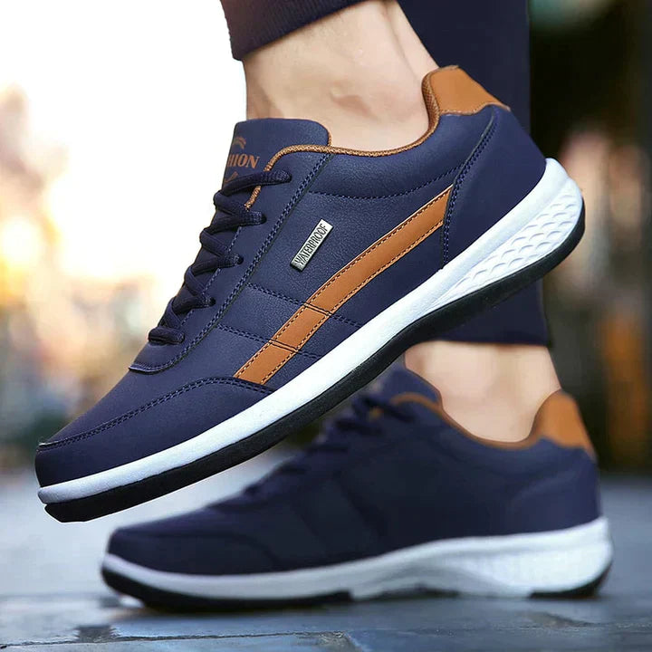 Navy blue and brown men's athletic sneakers with white soles, perfect for running and casual wear. Stylish, comfortable, and durable footwear.