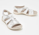 White leather women's sandals with adjustable straps and cushioned soles, perfect for summer fashion and comfortable walking.