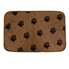 Brown quilted pet mat with black paw prints, durable fabric, non-slip backing, washable.
