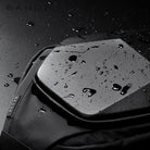 Water-resistant hardshell backpack by Bange, featuring sleek black design with water droplets, ideal for travel and outdoor activities.