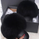 Black fluffy fur slippers in a gift box, luxury indoor footwear, cozy home fashion, soft faux fur slides, stylish comfort shoes for women.