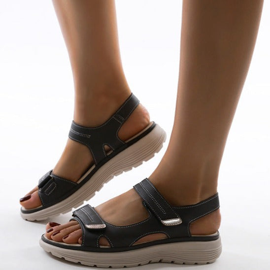 Women's black orthopedic sandals with adjustable straps and cushioned soles, designed for comfort and support. Ideal for walking and casual wear.