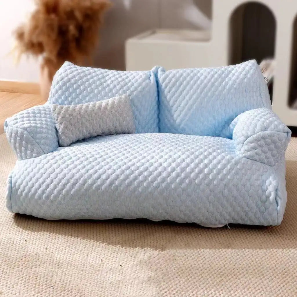 Light blue quilted pet sofa with plush cushion, perfect for small dogs and cats. Cozy, stylish pet furniture for living room or bedroom decor.