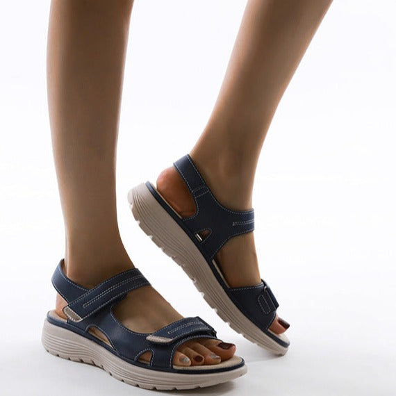 Women's navy blue orthopedic sandals with adjustable straps and cushioned soles, designed for comfort and support, ideal for walking and casual wear.