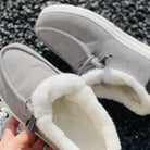 Gray corduroy winter slippers with plush white fleece lining, non-slip soles, and lace detail, perfect for cozy indoor wear.