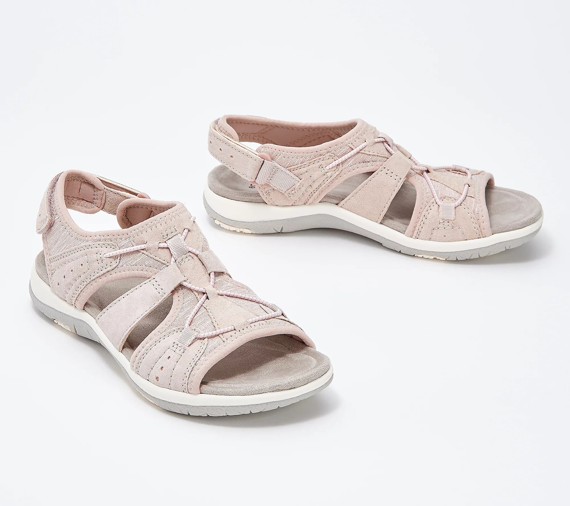 Women's pink strappy sandals with cushioned soles, ideal for summer fashion. Comfortable, stylish footwear perfect for casual outings and travel.