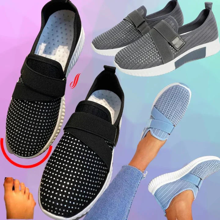 Women's slip-on sneakers with velcro, featuring rhinestone embellishments. Available in black, gray, and blue. Comfortable, stylish footwear.