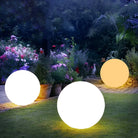 LED glowing spheres in a garden setting, illuminating a pathway with vibrant flowers and greenery; perfect for outdoor decor and landscape lighting.