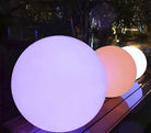 LED Glowing Spheres Outdoor Decor - Illuminated garden balls in purple, orange, and white, perfect for patio lighting and modern landscape design.