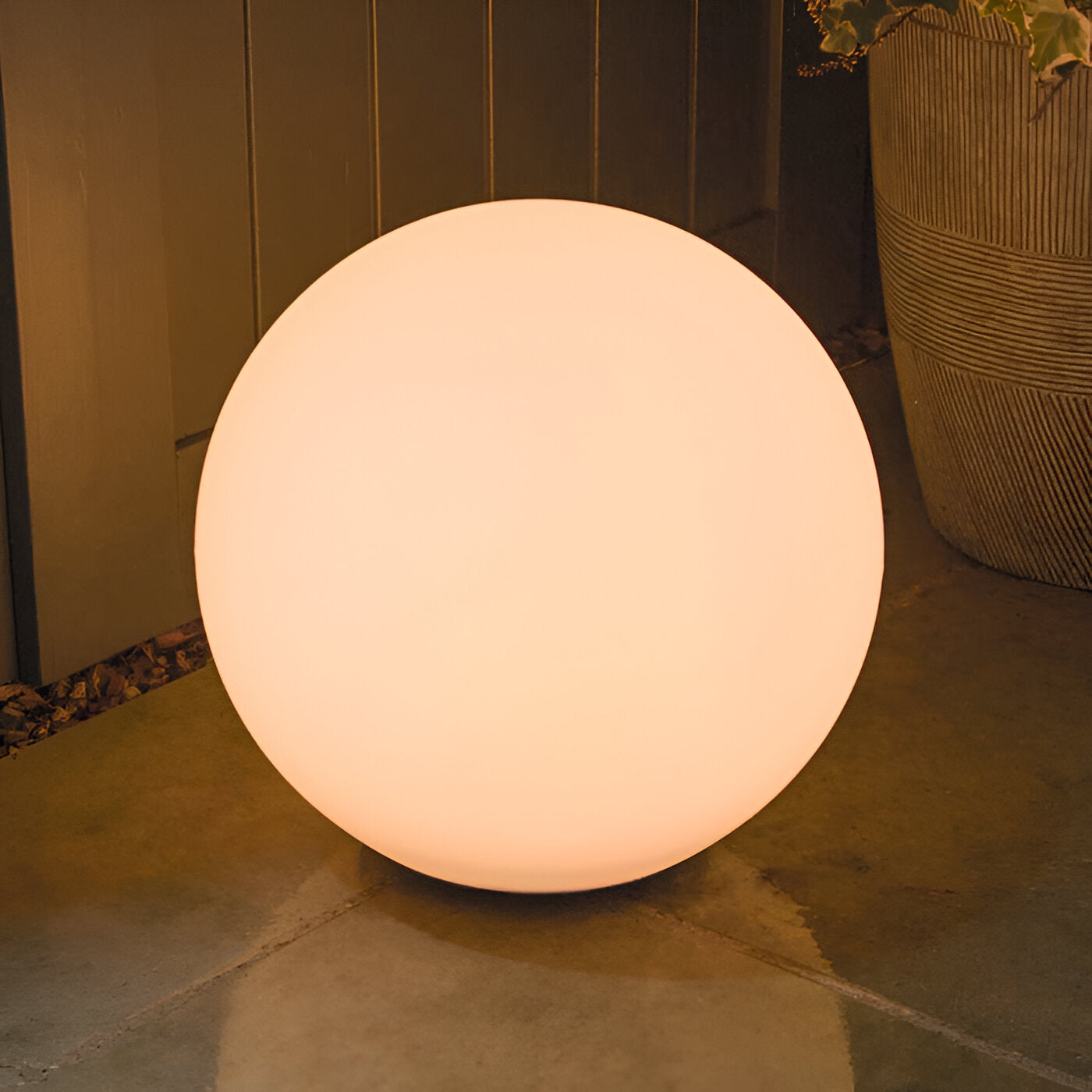 Glowing LED sphere light for outdoor decor, illuminating a patio with warm ambiance. Perfect for garden lighting, energy-efficient, modern design.