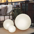 Glowing LED spheres on a modern balcony, featuring three illuminated orbs of varying sizes, perfect for outdoor decor and ambient lighting.