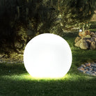 Glowing LED sphere light on grass, outdoor garden decoration, energy-efficient, modern landscape lighting, ambient night illumination, decorative orb.