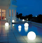 LED glowing spheres illuminate a modern outdoor pool area at night, enhancing ambiance. Perfect for garden decor, patio lighting, and outdoor events.