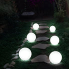 LED glowing spheres illuminate a garden path at night, creating a magical outdoor ambiance. Perfect for garden decor and landscape lighting.