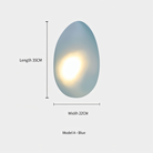 Blue pebble-shaped wall light, Model A, with soft glow, dimensions 35cm length and 22cm width. Modern home decor lighting fixture.