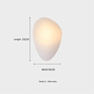 Modern pebble-shaped wall light in milk white, 25cm length, 16cm width. Ideal for ambient lighting, minimalist decor, and contemporary interiors.