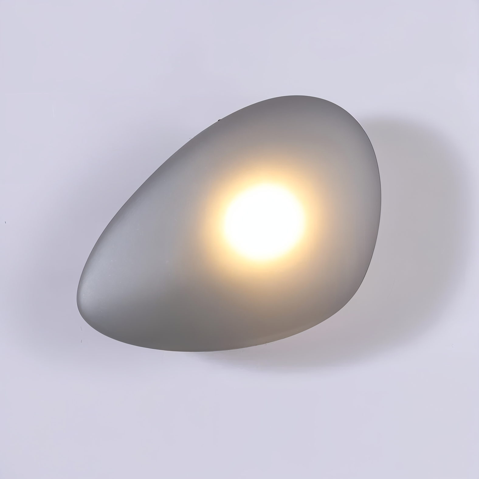 Modern pebble-shaped wall light with soft glow, minimalist design, ideal for contemporary home decor, energy-efficient LED lighting fixture.