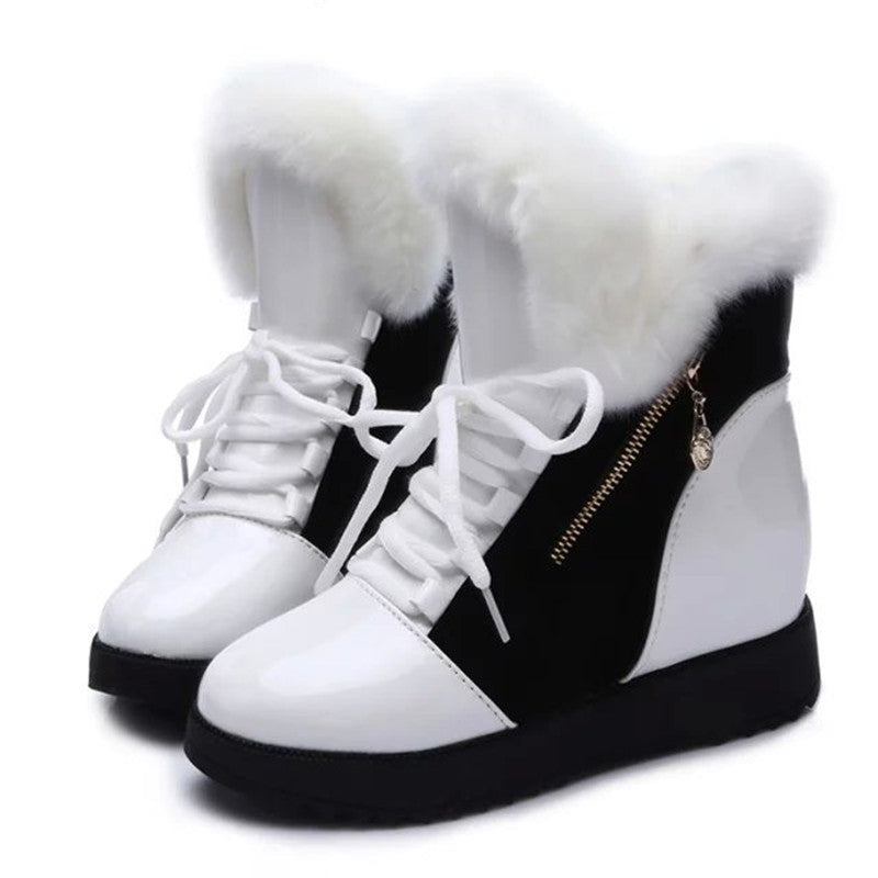 White and black women's winter snow boots with platform soles, thick fur lining, lace-up front, and side zipper. Warm, stylish footwear for cold weather.