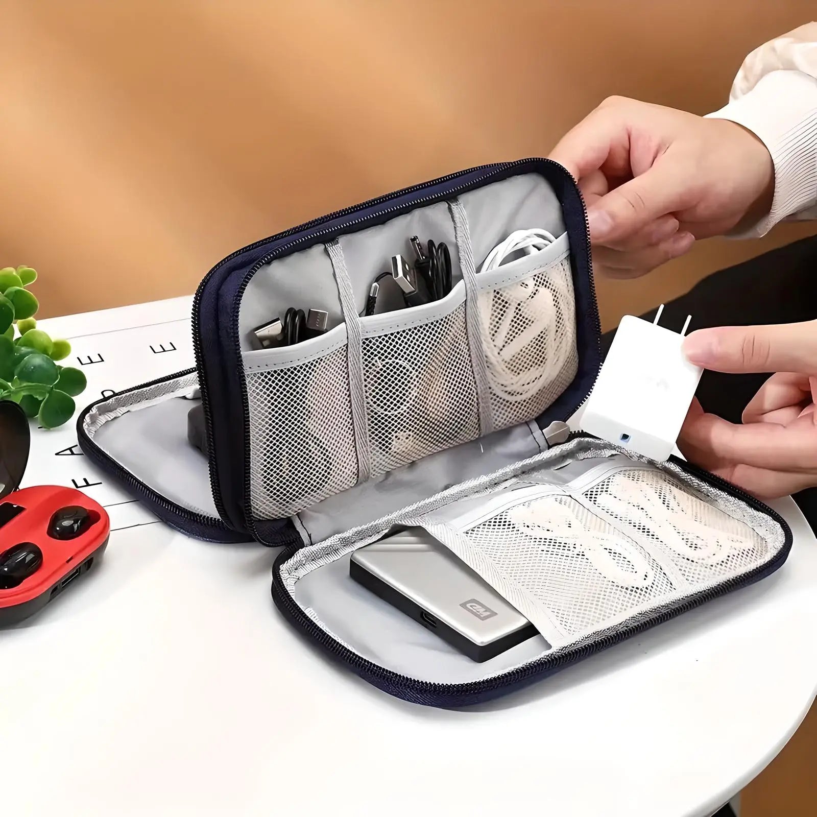 Travel electronics organizer with mesh pockets holding cables, charger, and power bank. Compact storage solution for tech accessories.