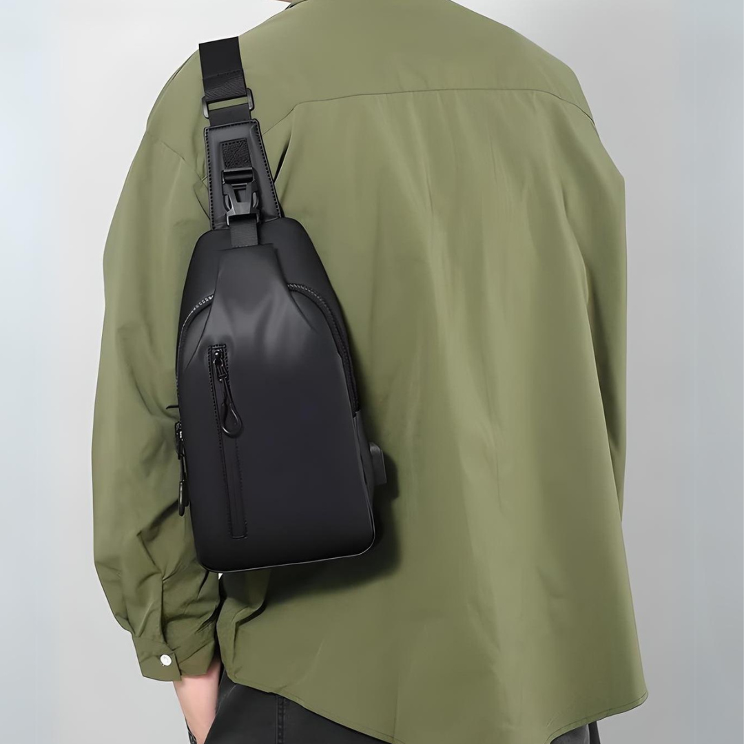 Man wearing a stylish black crossbody sling bag over a green shirt, showcasing modern fashion accessories for men. Ideal for travel and daily use.