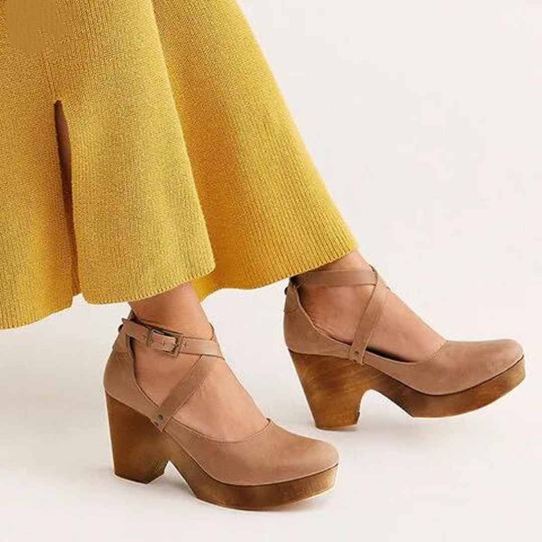 Women's khaki platform heels with ankle straps, paired with a yellow skirt. Stylish, modern footwear for fashion-forward outfits.