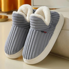 Cozy gray ribbed slippers with plush white lining, perfect for indoor comfort. Ideal winter footwear, non-slip sole, stylish home essentials.