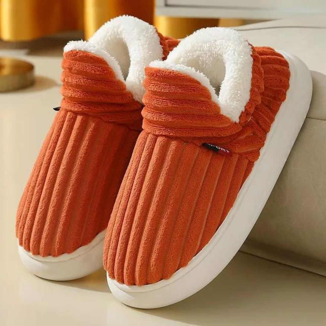 Cozy orange ribbed slippers with plush white lining, perfect for indoor comfort. Ideal winter footwear, stylish and warm.