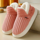 Cozy pink slippers with plush white lining, ribbed texture, and non-slip soles, perfect for indoor comfort and warmth. Ideal winter footwear.