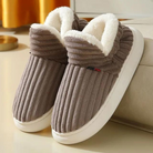 Cozy brown fleece slippers with plush white lining, ribbed texture, and non-slip soles, perfect for indoor comfort and warmth. Ideal winter footwear.