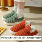 Cozy ribbed slippers with therapeutic soles in green and orange, designed for comfort and pain relief, perfect for indoor use.