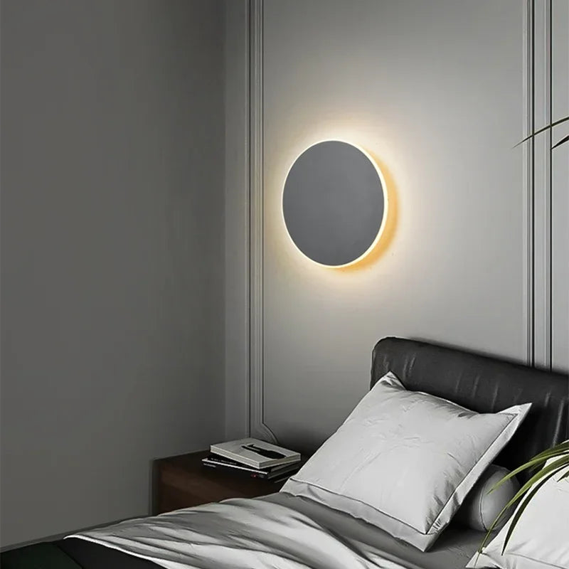 Modern minimalist LED round wall lamp with touch switch, illuminating a bedroom with soft ambient light. Ideal for contemporary interior design.