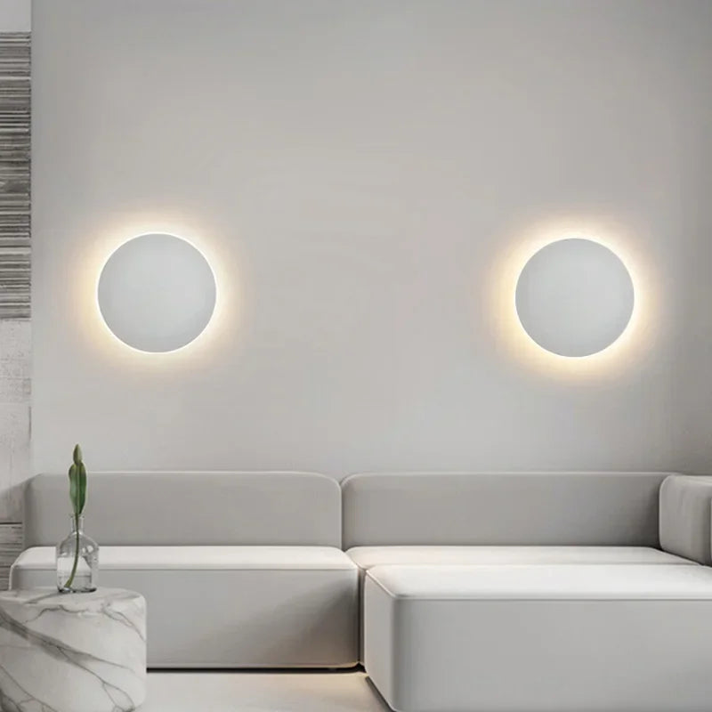 Modern minimalist LED round wall lamps with touch switch, illuminating a stylish living room. Ideal for interior design, bedroom, or stair lighting.