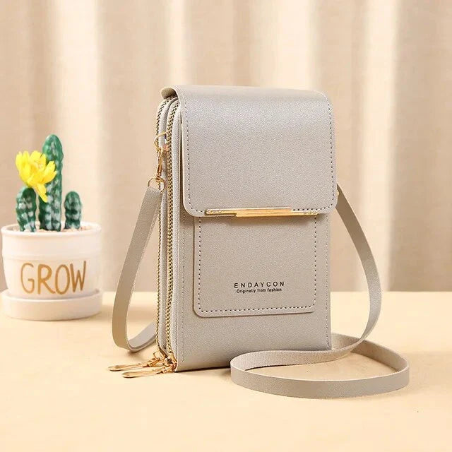 Elegant grey ladies shoulder bag with gold accents, featuring a sleek design and adjustable strap. Perfect for fashion-forward women.