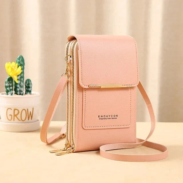 Light pink ladies shoulder bag with gold zippers and adjustable strap, perfect for casual outings. Stylish and compact design for women.