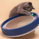 Gray cat playing with interactive circular cat toy featuring a blue rim and sisal scratching pad, engaging with colorful balls. Perfect for feline entertainment.