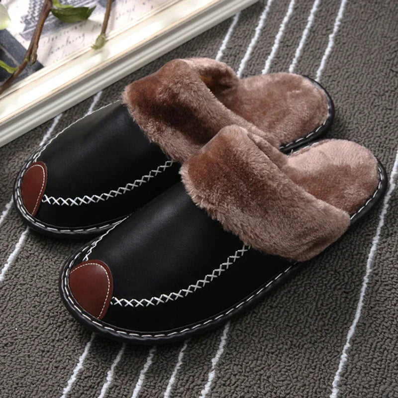 Cozy black slippers with plush brown lining, featuring white stitching and brown accents, perfect for indoor comfort and warmth. Ideal winter footwear.