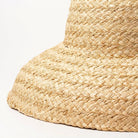 Wide-brimmed raffia straw hat for women, perfect for summer beach vacations. Features a flat top design, offering stylish sun protection.