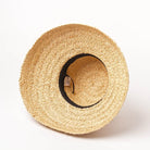 Wide-brimmed raffia straw hat with flat top, perfect for women's summer beach vacations. Stylish sun protection, UV resistant, chic accessory.