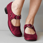 Women's burgundy Mary Jane shoes with low heels and buckle straps, featuring cutout details. Stylish, comfortable footwear for casual and formal occasions.