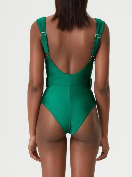 Woman wearing a green one-piece swimsuit with adjustable straps, back view. Fashion swimwear, summer beachwear, stylish bathing suit.